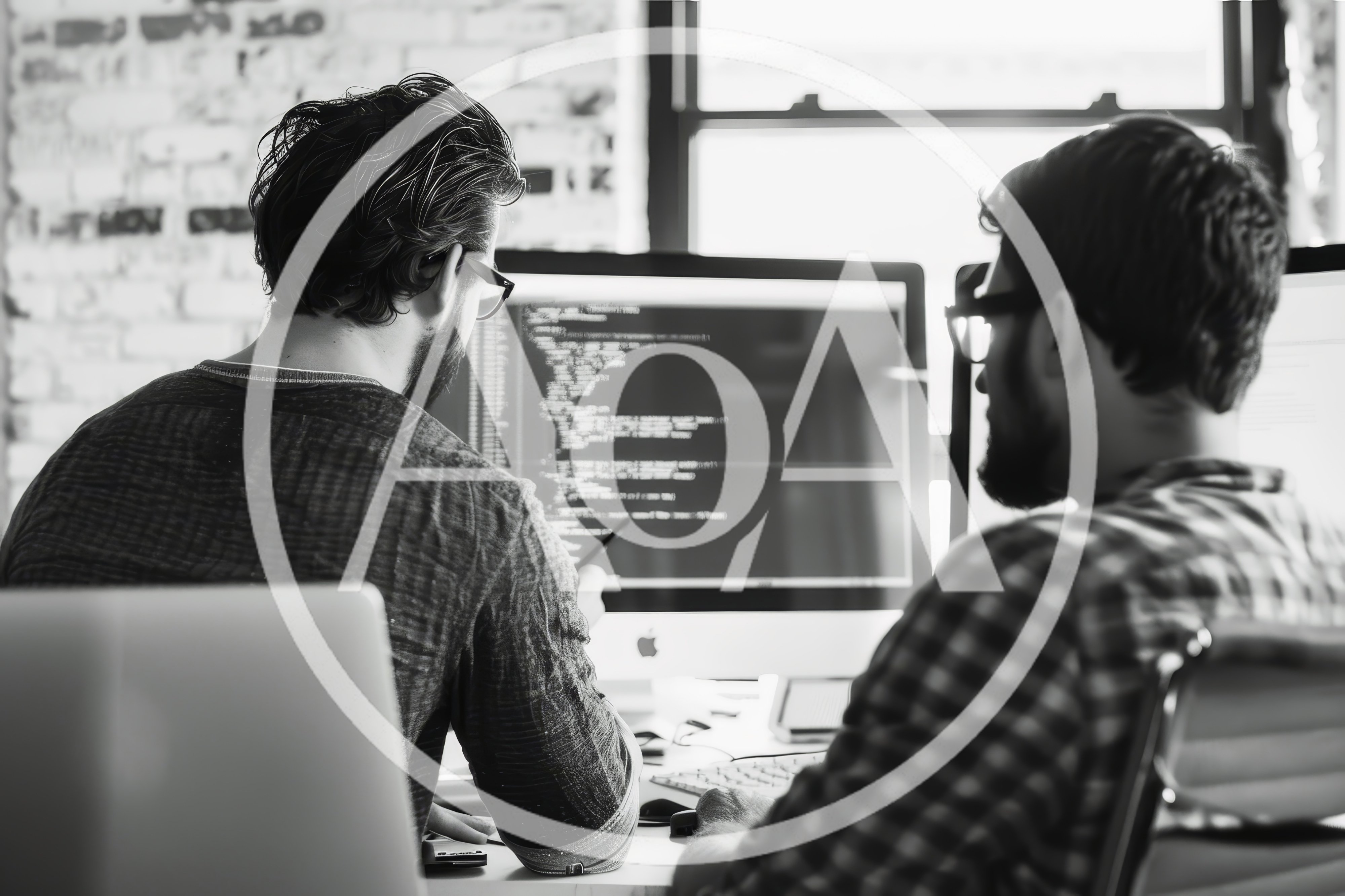 Two Software Developers Collaborating On Code In Office