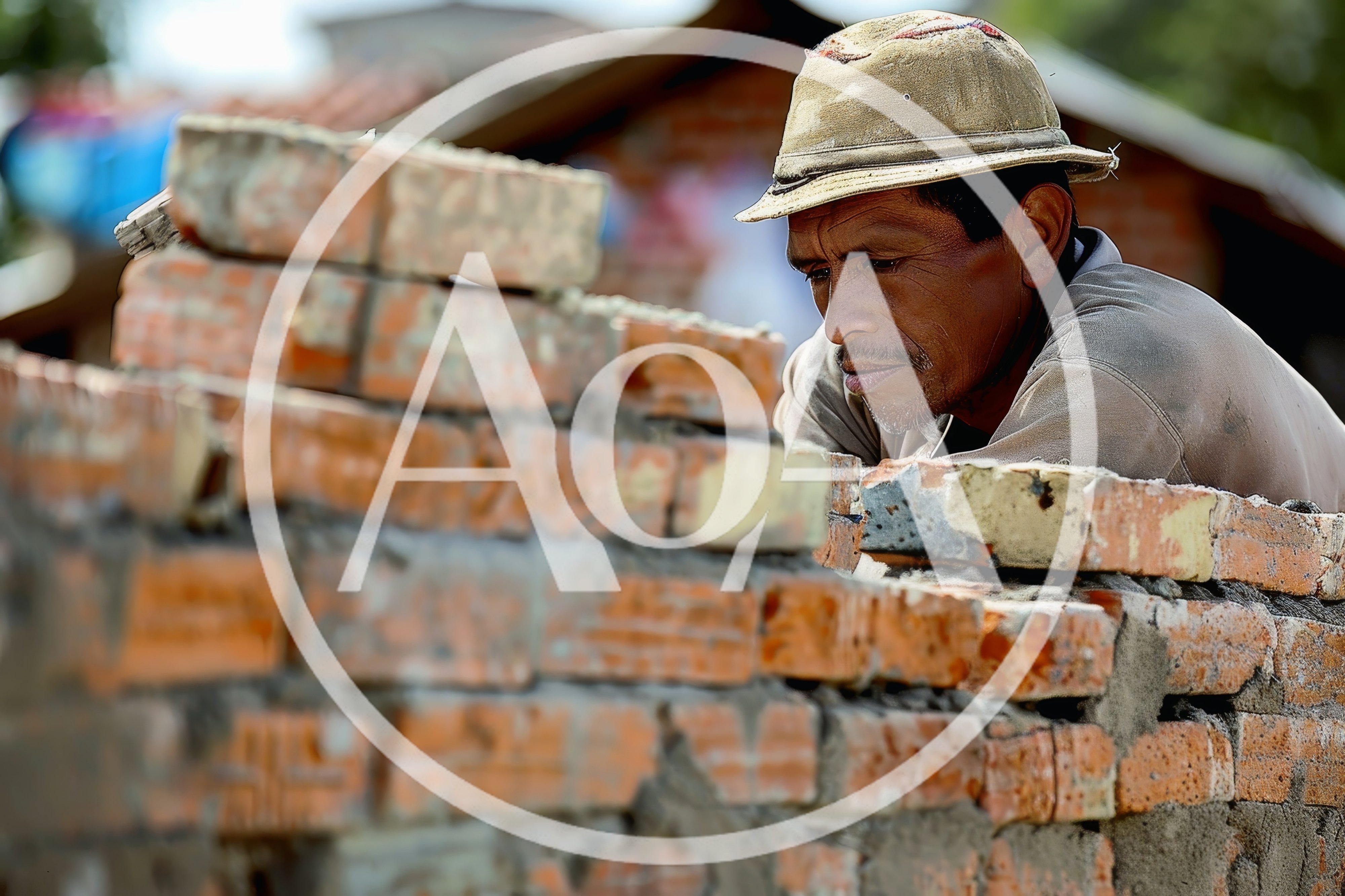 Construction Worker Laying Bricks For A Wall