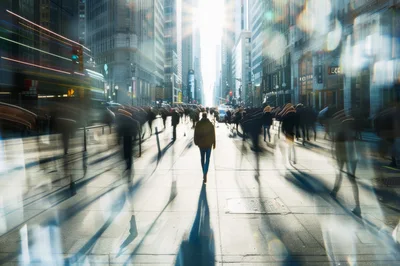Blurred Commuters Walking Down A Busy City Street
