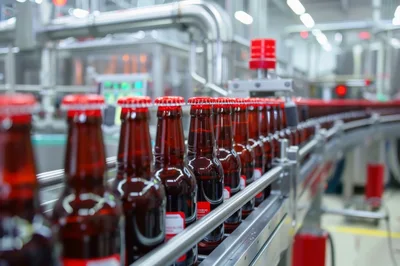 Brown Glass Beer Bottles Moving On Industrial Conveyor Belt