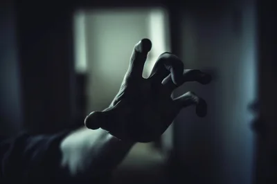 Creepy Human Hand Reaching Out From Darkness