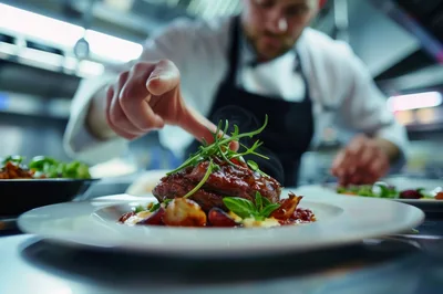 Professional Chef Plating Gourmet Steak Dish