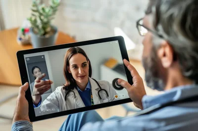 Senior Man Having A Telehealth Consultation On Tablet