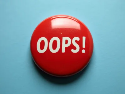 Red Oops Button On Blue Background