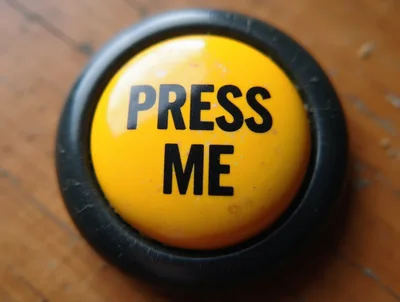 Yellow Press Me Button On Wooden Surface