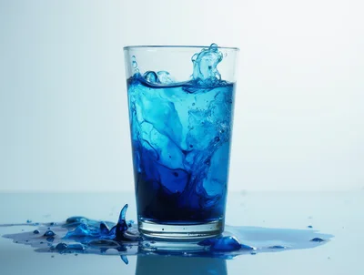 Blue Liquid Splashing Out Of A Glass
