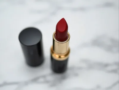 Red Lipstick With Cap On Marble Surface