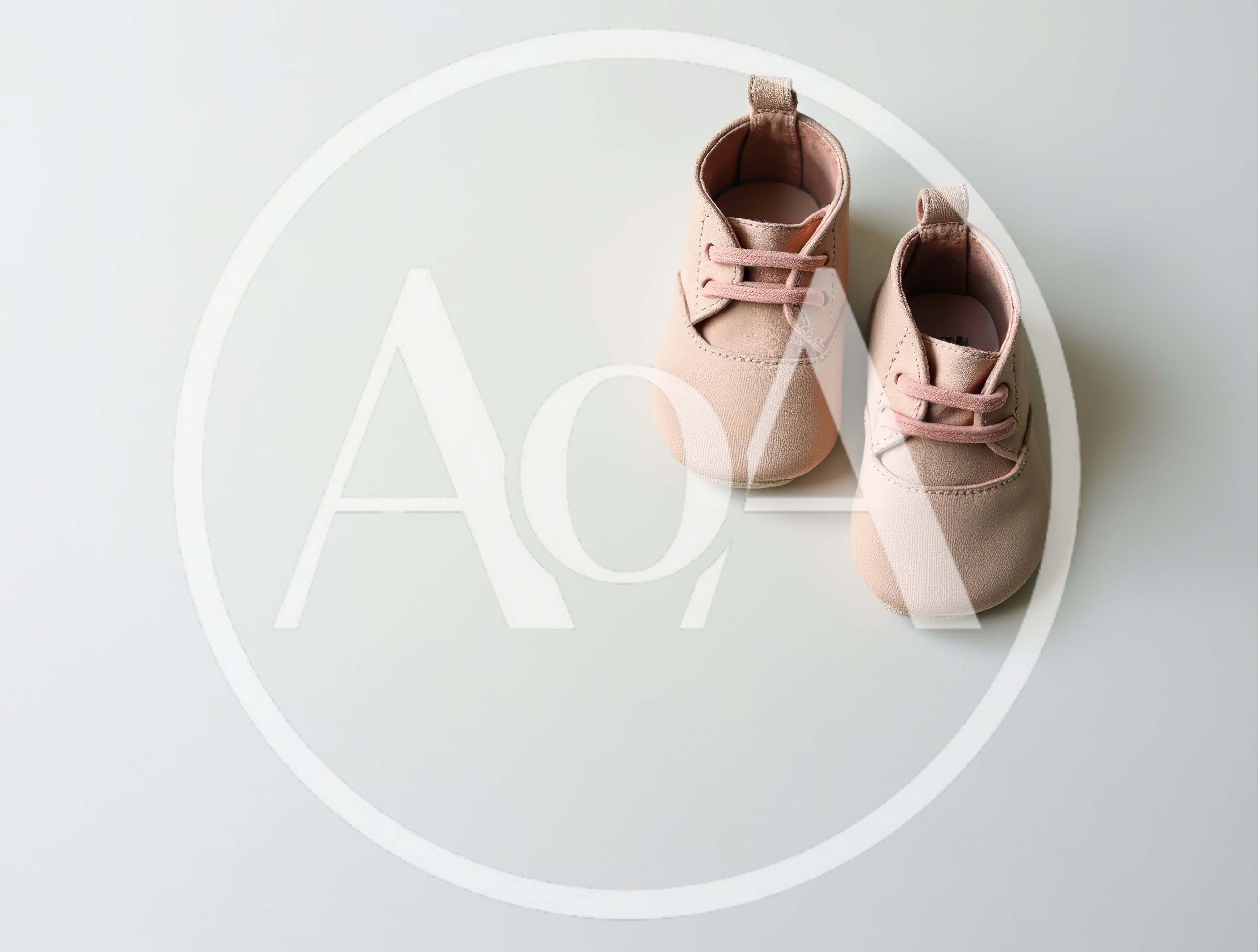 Pair of Soft Pink Baby Shoes on White Background