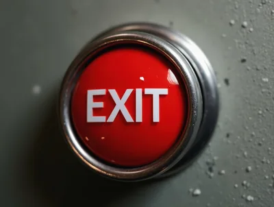 Red Exit Button Mounted On A Textured Wall