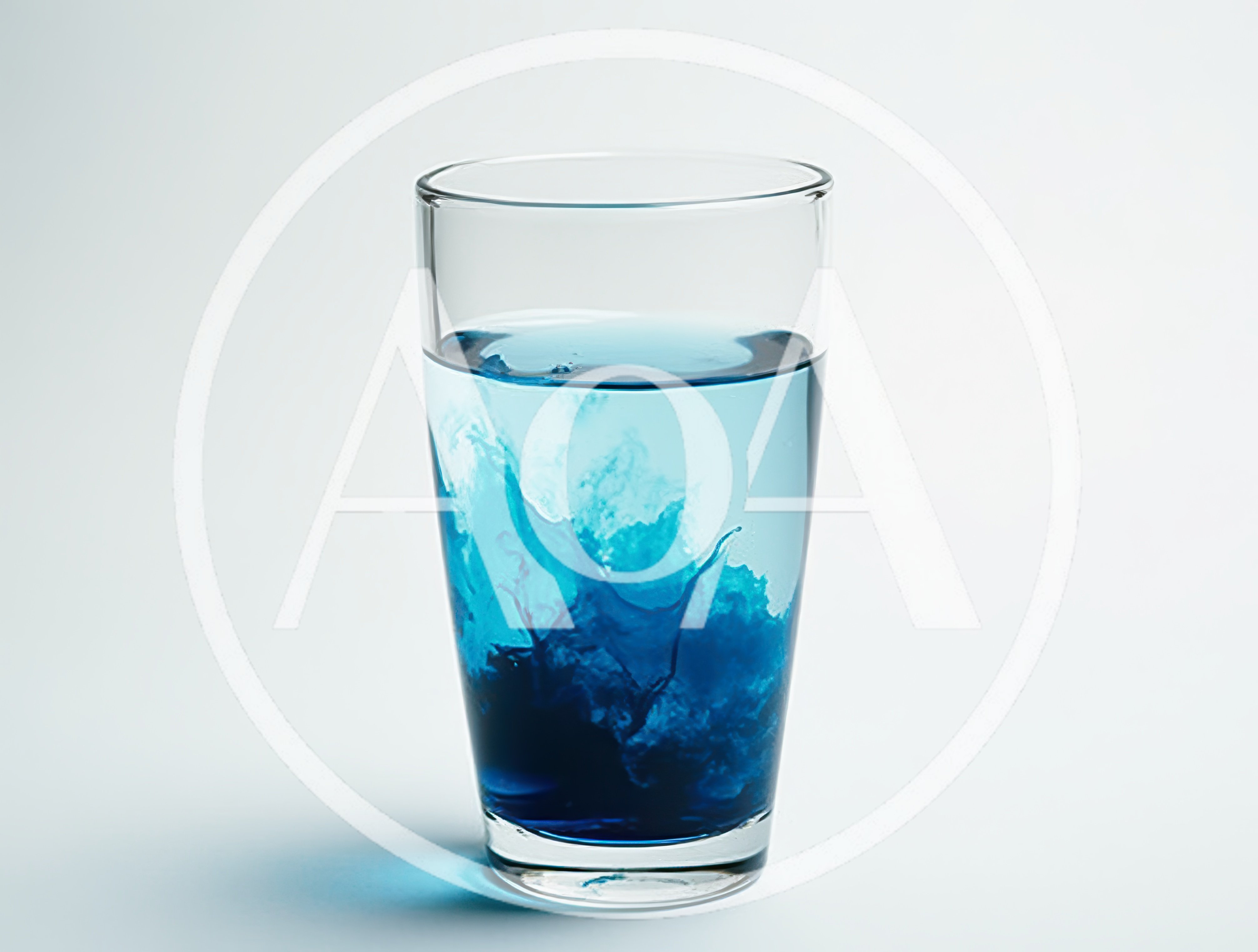 Blue Dye Swirling Inside A Clear Glass Of Water