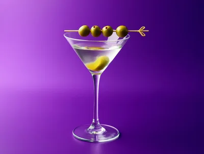 Classic Martini Cocktail With Four Olives On A Skewer