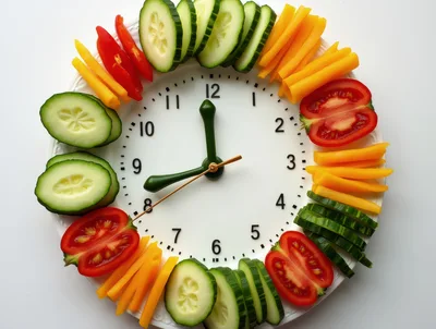 Clock Face Made Of Fresh Vegetables On White Plate