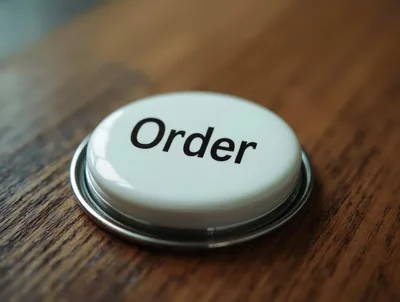 White Order Button On A Wooden Surface