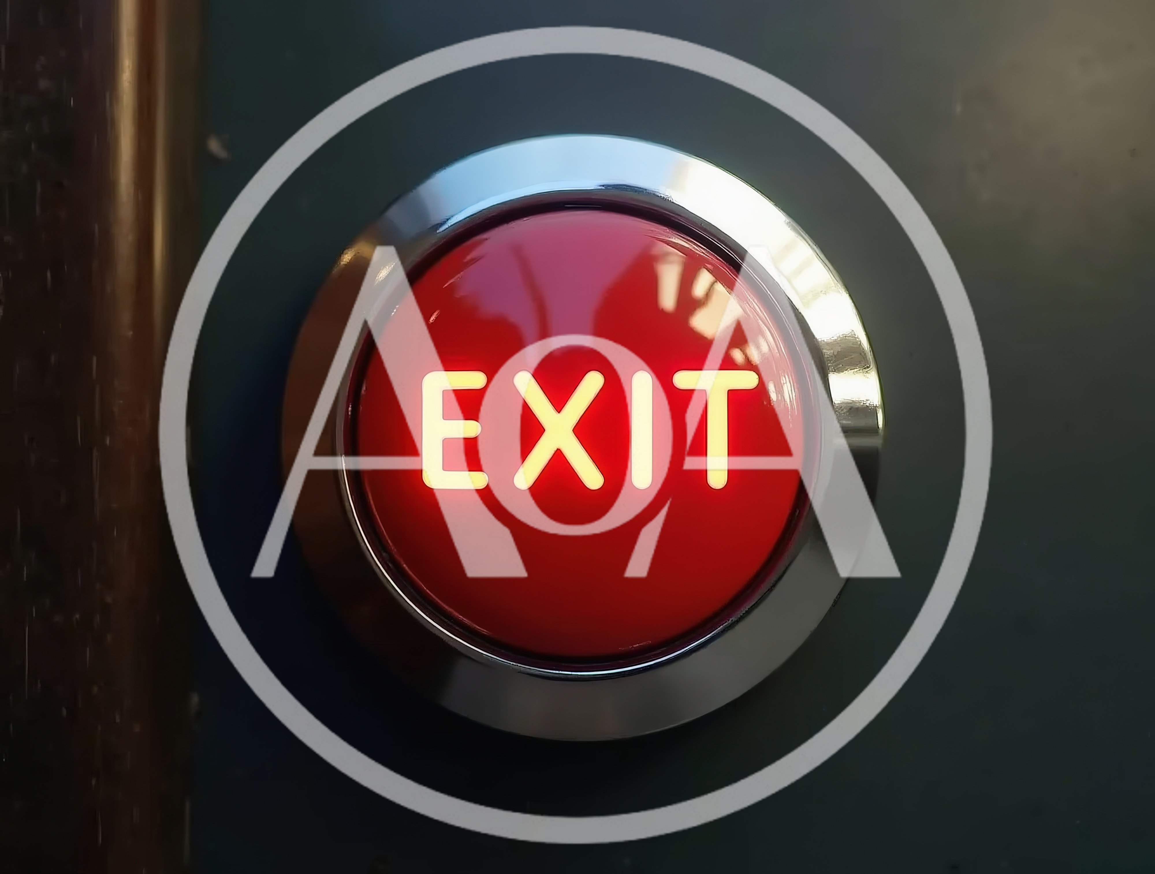 Illuminated Red Exit Push Button On Dark Wall