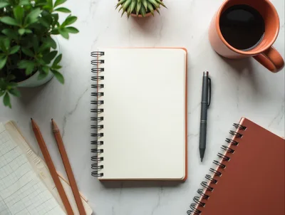 Top View Of A Desk With Notebooks And Coffee