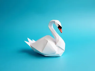 White Origami Swan Paper Sculpture on Blue Background