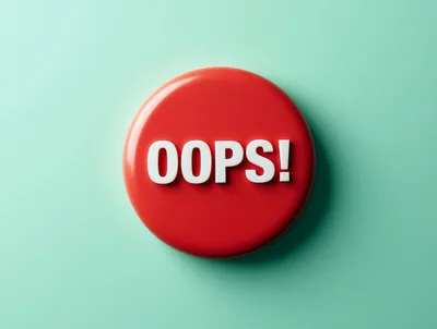 Red Circular Button With White Oops Text