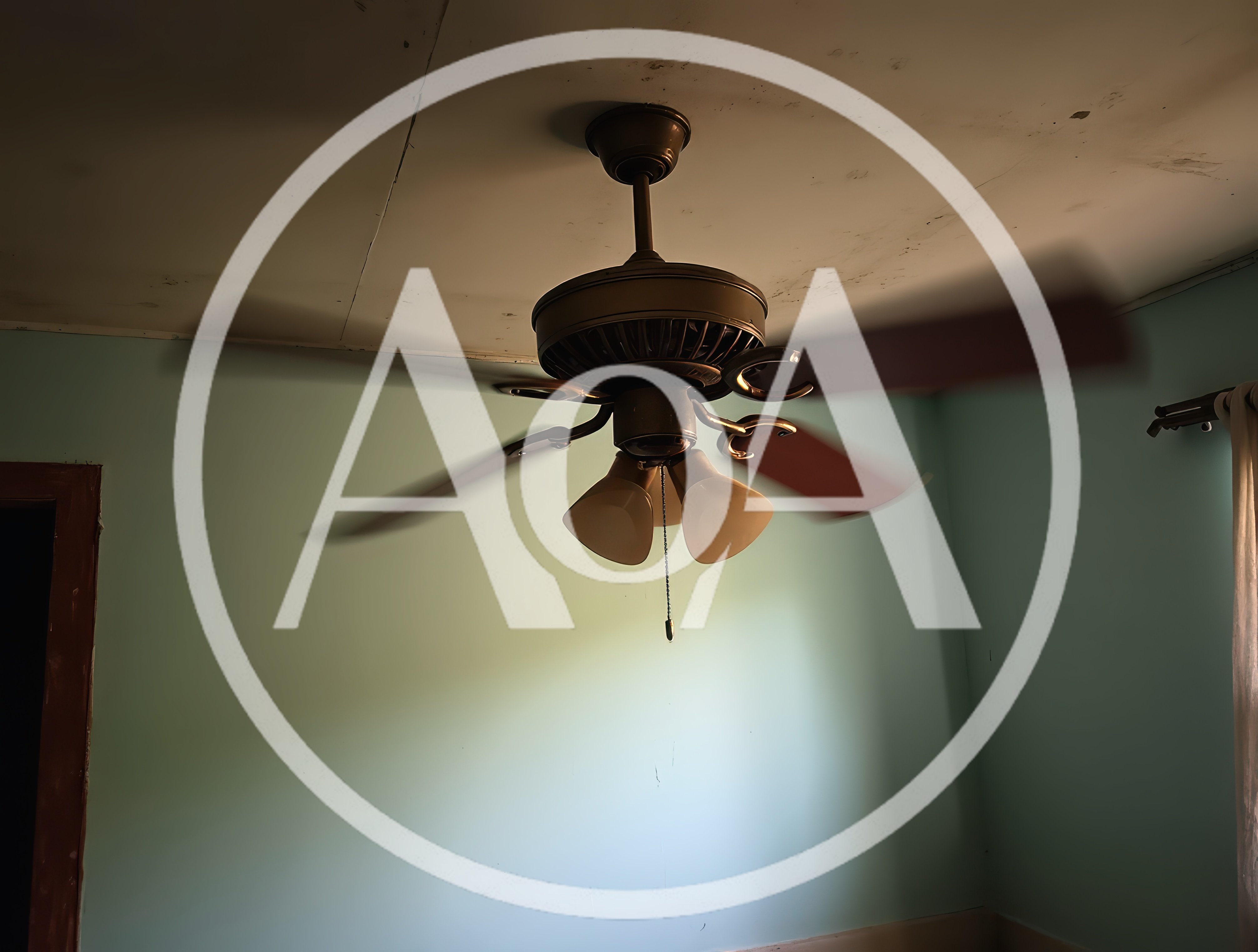 Vintage Ceiling Fan Spinning In A Dimly Lit Room