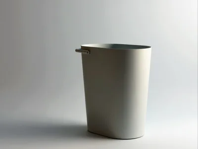 Minimalist White Wastebasket On A Plain Background