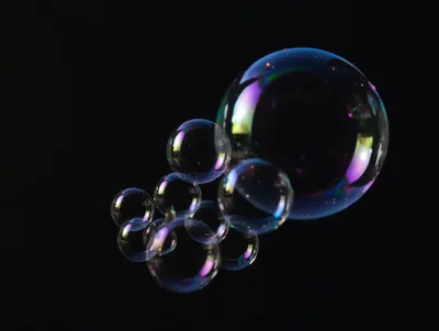 Floating Soap Bubbles Against A Black Background