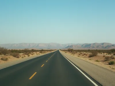 Empty Asphalt Highway Through Arid Desert Landscape