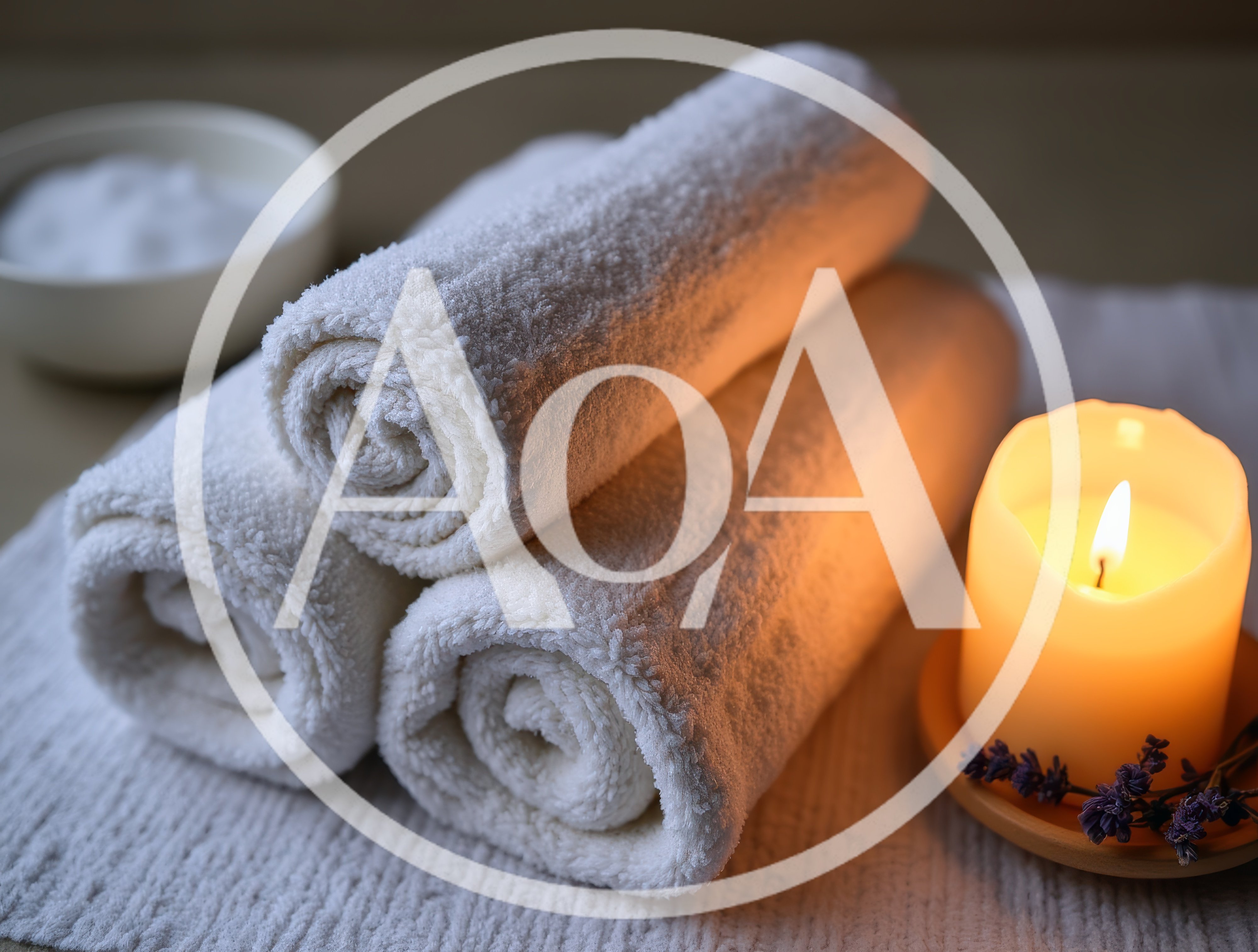 Spa Relaxation Setup With Rolled Towels And Candle