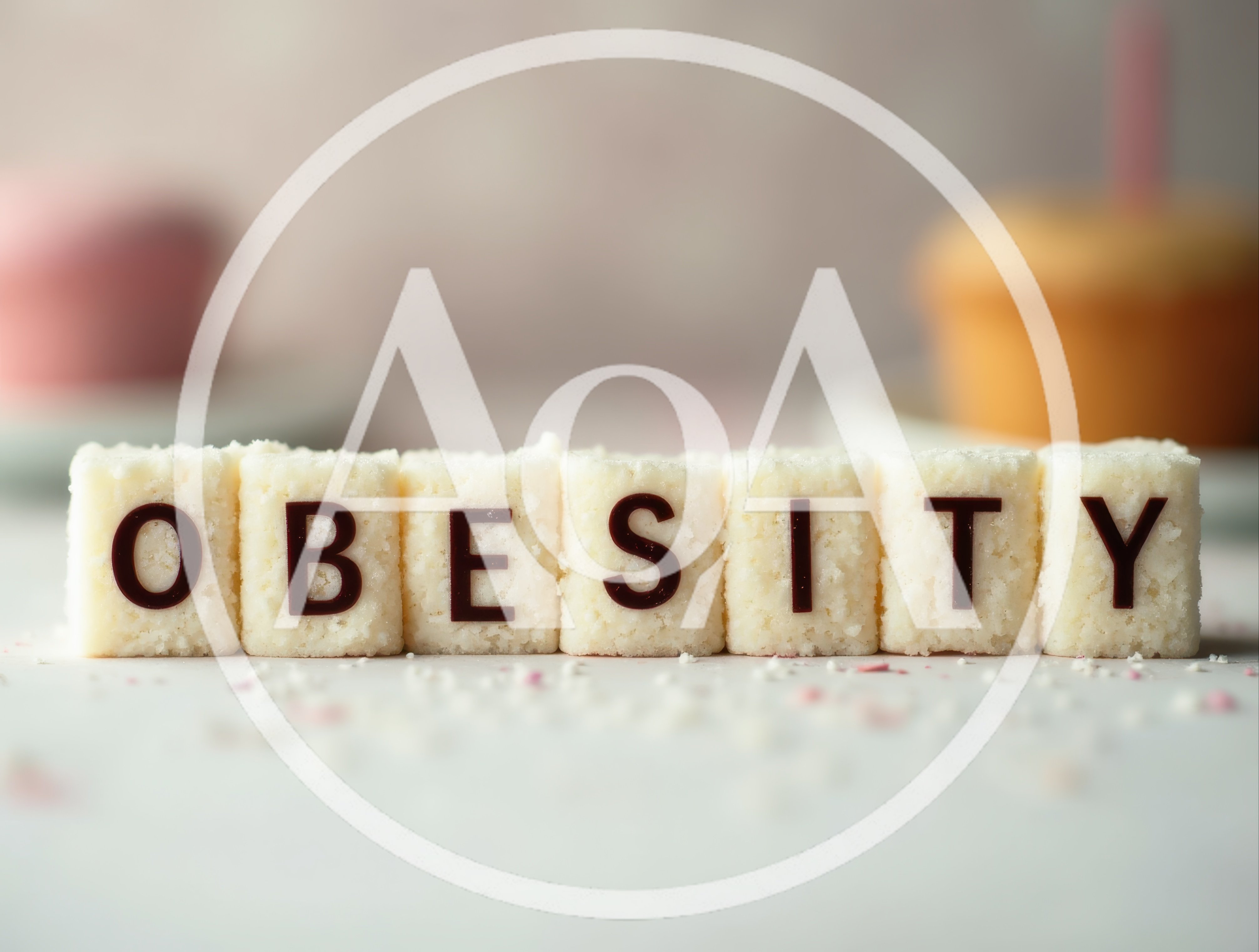 Sugar Cubes Spelling Obesity With Blurred Cupcakes Background