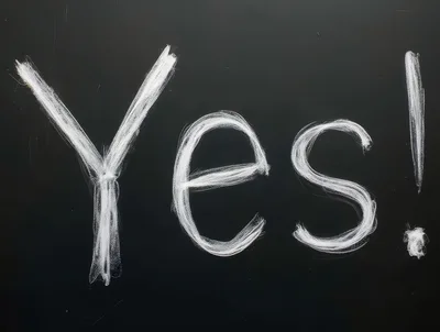 Yes Written In White Chalk On A Black Blackboard