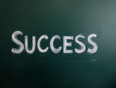Success Written In White Chalk On A Green Blackboard
