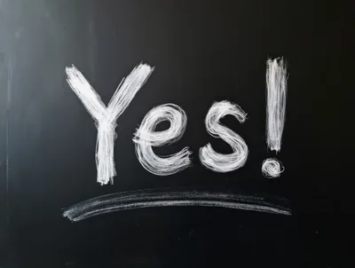 Yes Written In White Chalk On A Black Blackboard