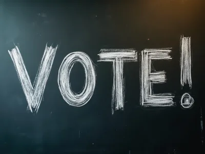 White Chalk Text Vote Written On A Black Blackboard