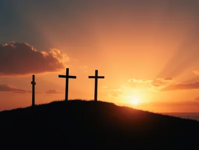Three Wooden Crosses Silhouetted Against A Vibrant Sunset