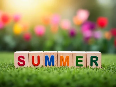 Wooden Blocks Spelling Summer On Green Grass