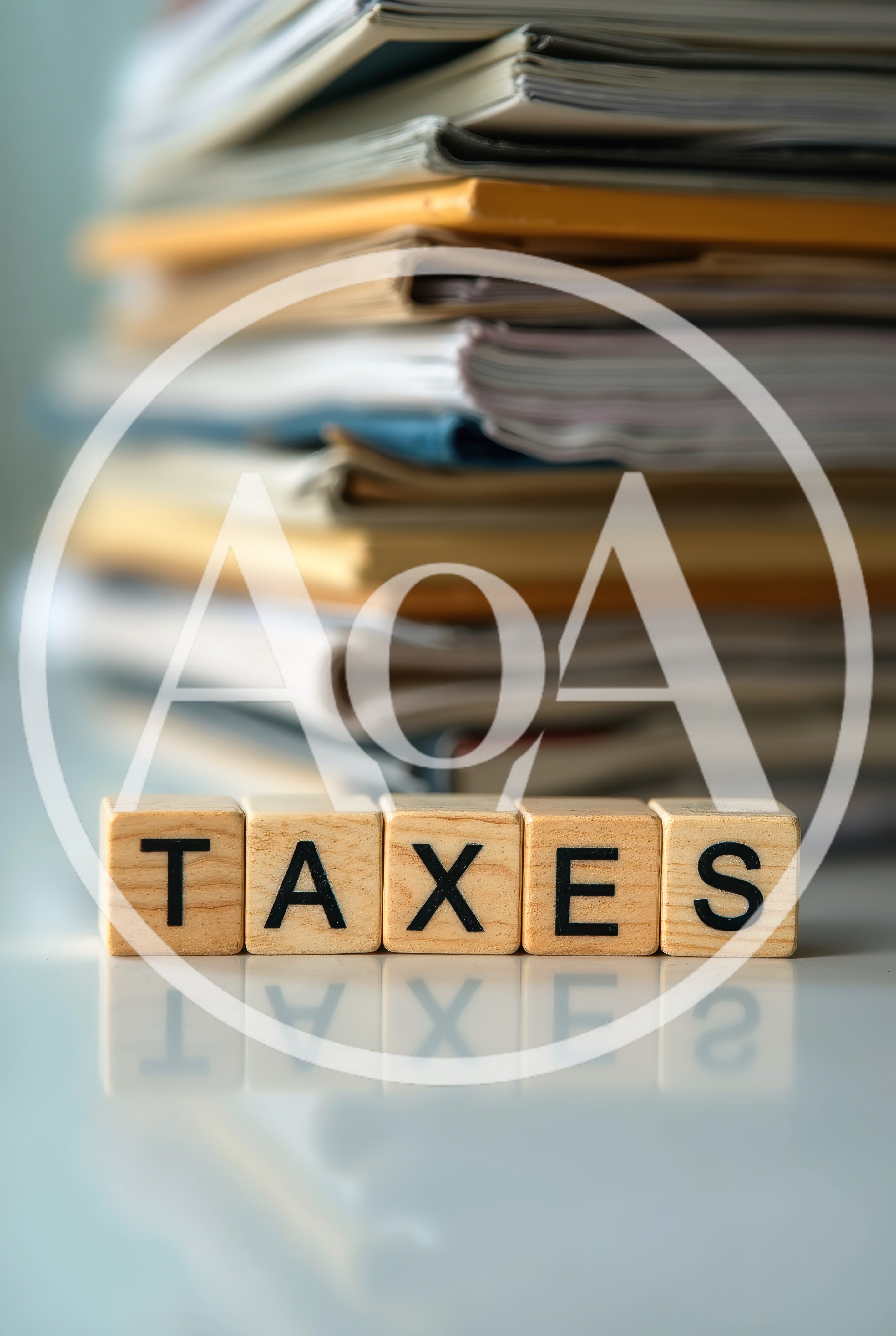 Wooden Blocks Spelling Taxes With Stacked Paperwork Background