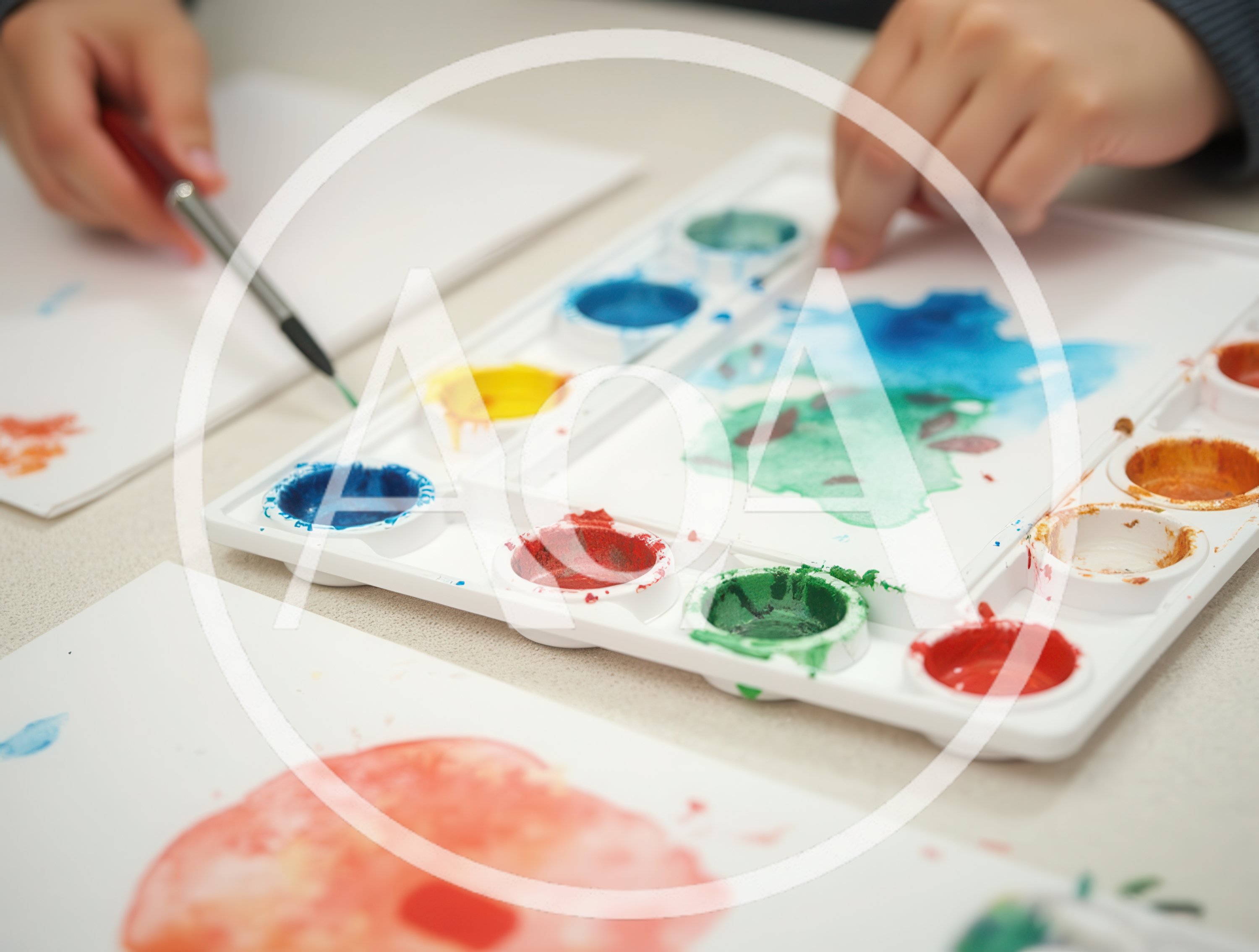 Child Painting With Watercolors On Paper