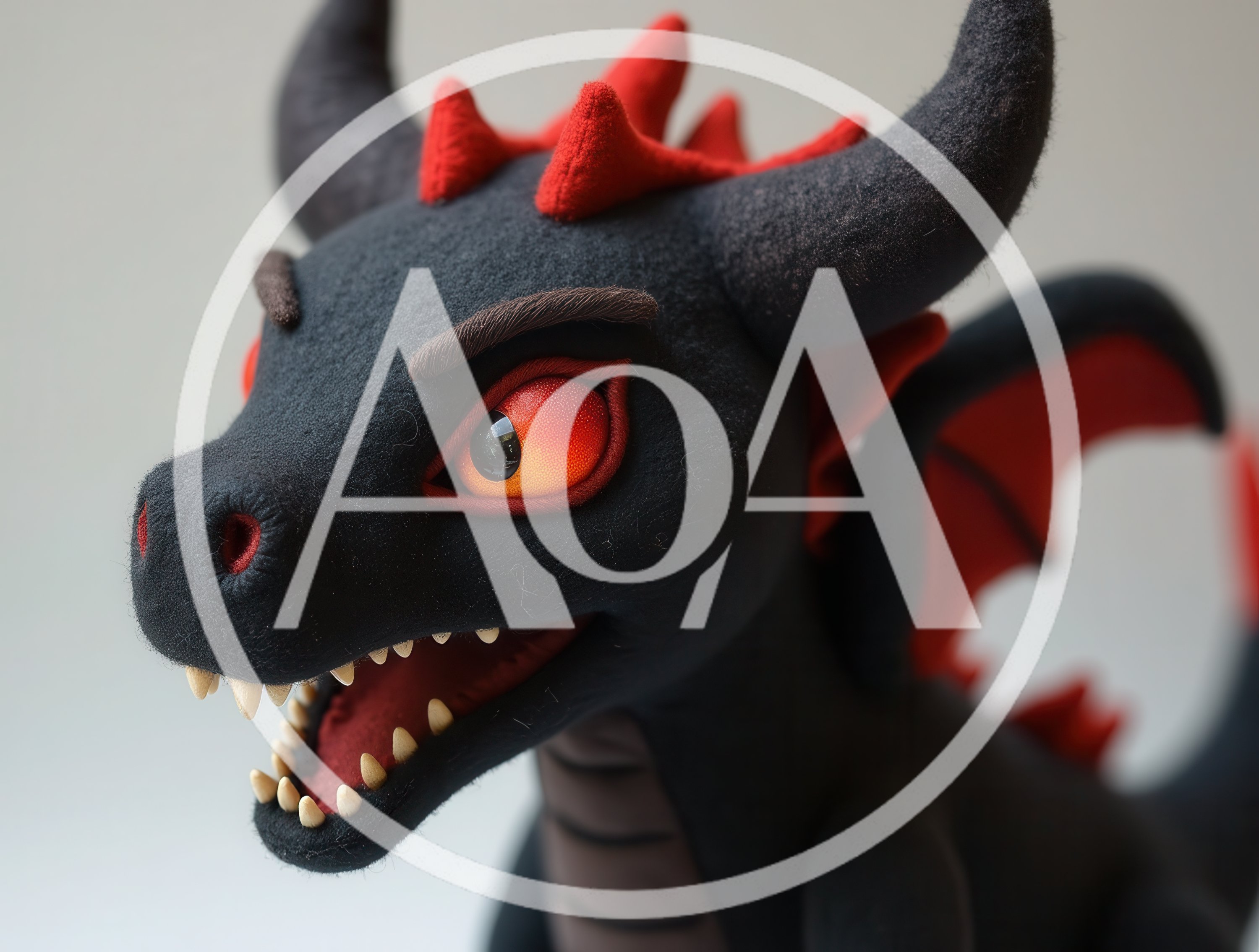 Close Up Of A Black And Red Dragon Plush Toy
