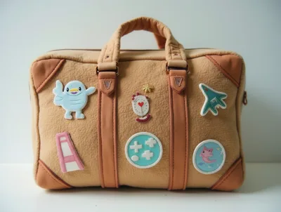 Tan Felt Travel Bag With Decorative Patches