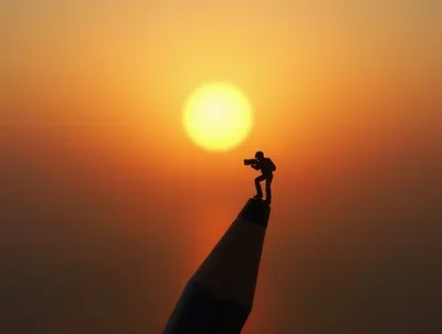 Miniature Photographer Standing On A Pencil Tip