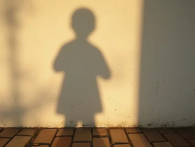 Shadow Of A Child On A Wall