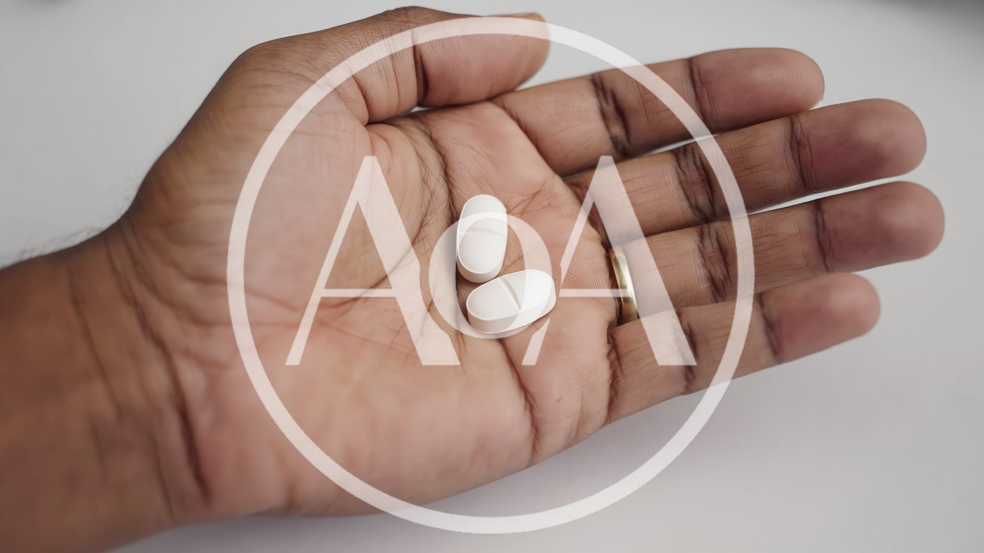 Person Holding Two White Oval Pills In Palm