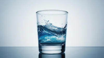 Glass Of Water With Turbulent Ocean Waves Inside