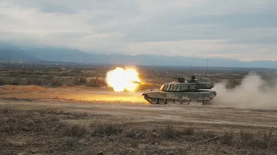 Main Battle Tank Firing Cannon in Desert Landscape