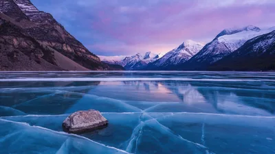 Frozen Lake Abraham With Cracked Ice And Mountain Backdrop