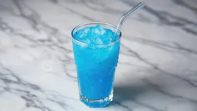 Blue Iced Drink in Glass with Straw