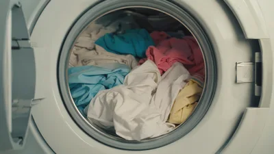 Open Washing Machine Filled With Colorful Laundry