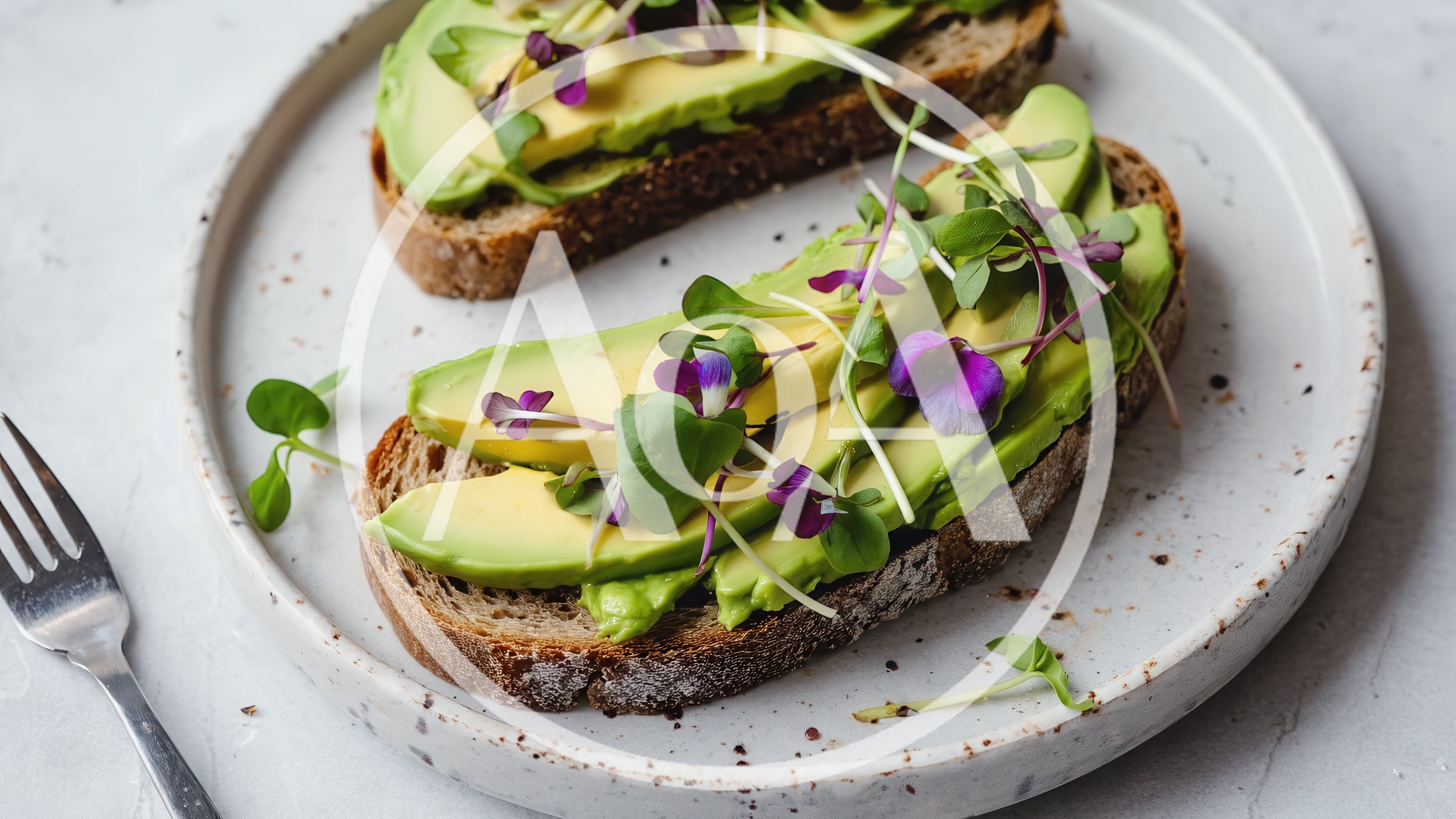 Two Slices Of Avocado Toast With Microgreens And Flowers