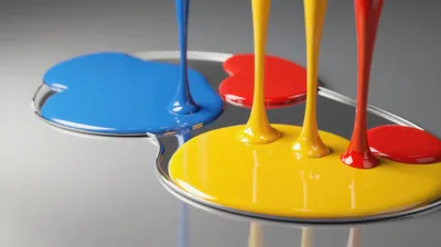 Primary Colored Paint Streams Pouring Onto Reflective Surface