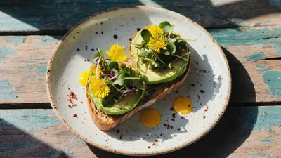 Avocado Toast With Edible Flowers On Rustic Plate