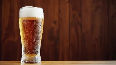 Cold Glass Of Beer On Wooden Table