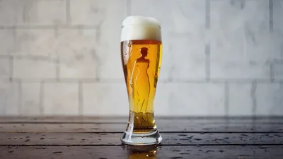 Glass Of Beer With Silhouette Of A Woman